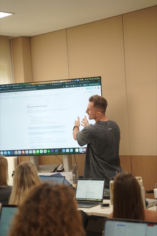 Ross explaining a prompt on a big screen