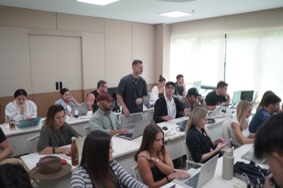A full room of laptops at an AI Powered workshop